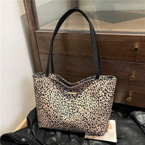 Classic leopard print tote bag with black shoulder straps and a gold logo plaque