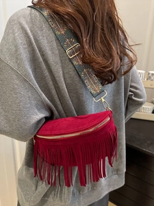 Bohemian burgundy suede fanny pack with long tassels and patterned wide shoulder strap
