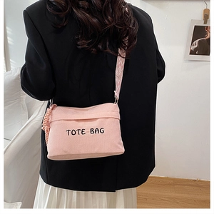 Pink corduroy crossbody tote bag featuring a stylish patterned wide shoulder strap