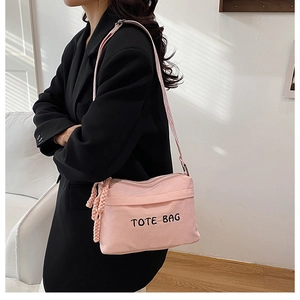Pink corduroy tote bag with black letter embroidery on oversized shoulder bag