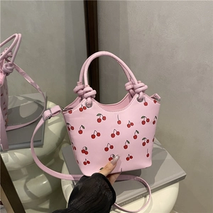 Pink cherry print tote bag with woven knot handle and adjustable shoulder strap