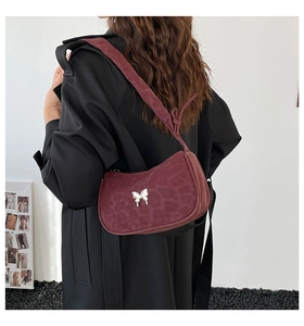 Detail view of the wine red leopard print bag with silver butterfly metal buckle