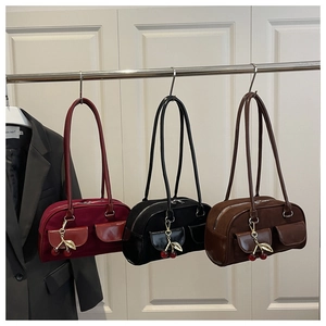 Detailed comparison of three suede handbags in burgundy, black and brown with cherry charms