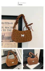 Detailed close-up of leopard print shoulder bag featuring silver butterfly buckle and ruffles