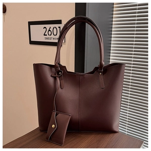 Detailed view of dark brown faux leather tote bag with matching mini coin purse attachment