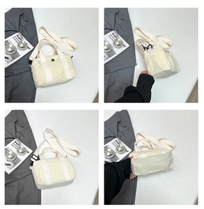 Detail view of cream washed canvas crossbody bag with wrinkled texture and woven handles