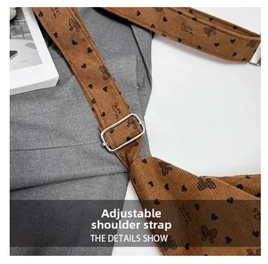Detail of adjustable silver buckle and brown corduroy strap with sweet candy print