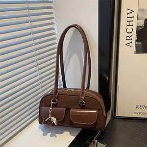 Retro brown suede shoulder bag with cherry pendant and leather stitching in a vintage style