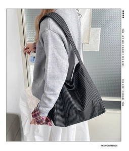 Detail of checkered canvas tote bag showing seamless shoulder strap and large capacity