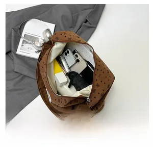 Interior view showing large capacity of the brown corduroy tote with daily essentials