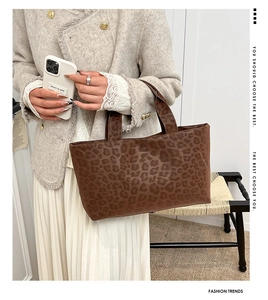 Close-up of stylish brown leopard print tote bag in soft suede fabric for women