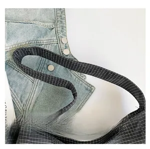 Close-up of black and white plaid tote bag featuring a wide woven comfortable strap