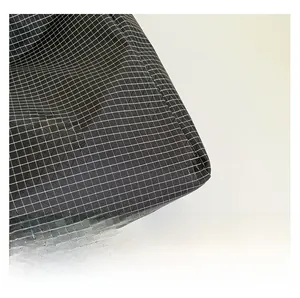 Detailed close-up of high-quality black ripstop fabric with white grid pattern on the bag