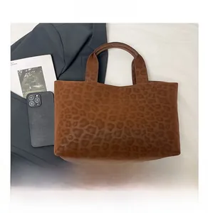 Macro shot of brown leopard print tote bag with soft texture and sturdy handles