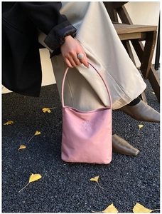 Detail of pink small tote bag with Hope and Future embroidery on textured fabric