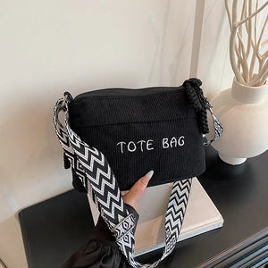 Classic black corduroy tote bag with embroidered letters and geometric wide shoulder strap