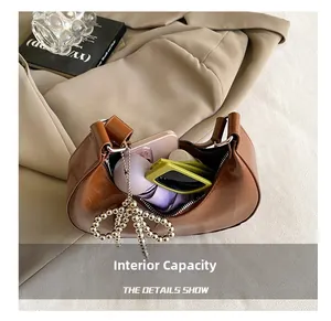 Detailed interior of vintage brown hobo bag showing capacity for phone and sunglasses