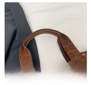Close-up of the comfortable leopard print shoulder strap and faux leather texture on the tote