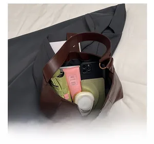 Macro detail showing the large interior storage capacity of this vintage brown tote bag