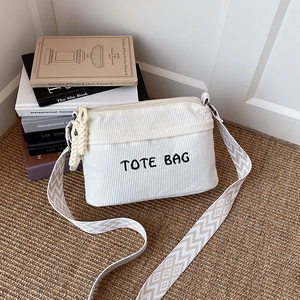 White corduroy tote bag with TOTE BAG embroidery and stylish wide patterned strap