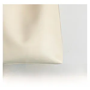 Close-up of premium leather texture and precise stitching on vintage tote bag corner