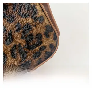 Close-up detail of leopard print leather texture and premium brown pattern finish