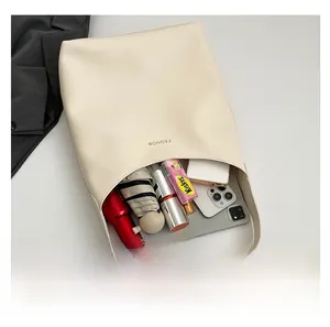 Top view of cream tote bag interior showing large capacity for phone and umbrella