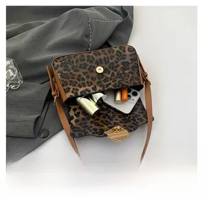 Detailed interior of leopard print shoulder bag showing space for phone and makeup