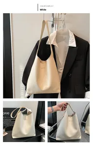 Detailed view of the white leather tote bag with elegant gold Fashion lettering