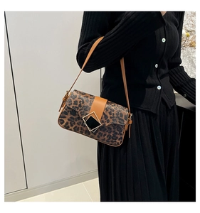 Close-up of leopard print shoulder bag featuring a square golden buckle and brown strap