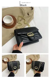 Detail view of black quilted crossbody bag with golden chain strap and square lock