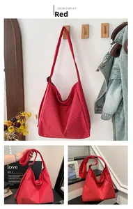 Detail of red and white checkered canvas tote bag showing shoulder strap and plastic buckle