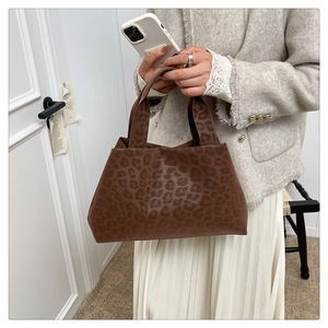 Close-up of leopard print tote bag with brown handles and high capacity storage