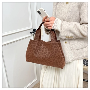 Chic leopard print tote bag styled with a beige tweed jacket and a white pleated skirt