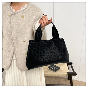 Close-up of leopard print velvet tote bag texture and durable top handle details