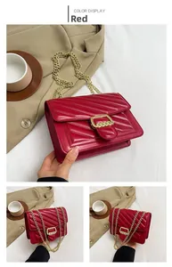 Detailed view of red quilted leather crossbody bag with golden chain and V-pattern stitching
