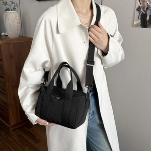 Waterproof black nylon mini Boston bag with double handles and adjustable crossbody strap