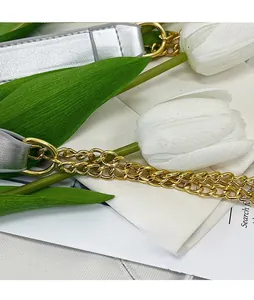 Detail of silver leather and gold metal chain strap for women shoulder bag
