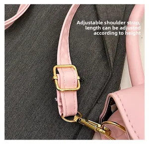 Macro view of pink leather adjustable shoulder strap with premium golden metal buckle