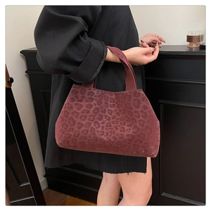 Detail view of burgundy leopard print tote bag with plush texture and short handles