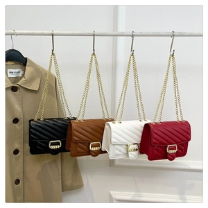 Detailed view of quilted leather crossbody bags with golden chain straps in four colors