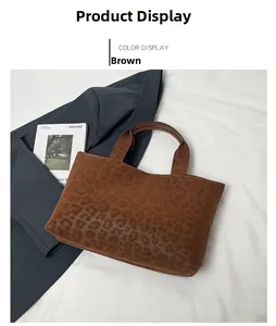 Close-up of leopard print tote bag with brown pattern on a minimalist fabric background