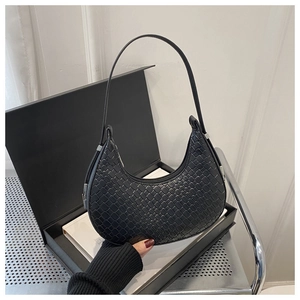 Close-up of black woven texture on minimalist crescent hobo bag for women
