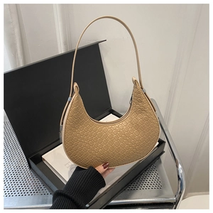 Detail of beige crescent underarm bag with crocodile embossed texture and zipper closure