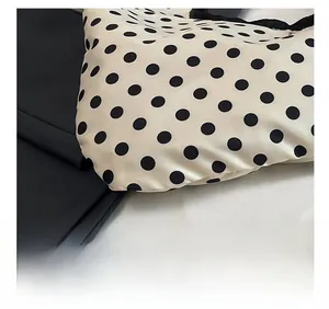 Macro shot of precise stitching on black polka dot fabric with black textile splicing
