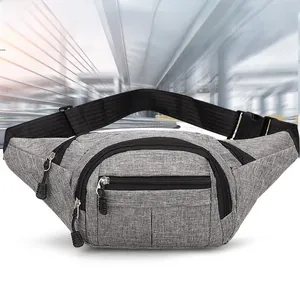 Detail view of the gray linen texture fabric and multiple zippered compartments of the bag