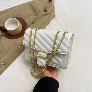 White quilted chain crossbody bag with gold buckle and minimalist leather finish