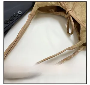 Close-up of suede texture and durable shoulder strap on the large brown tote bag