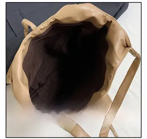 Interior view of large capacity khaki tote bag showing deep brown fabric lining and space