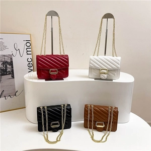 Quilted crossbody chain bag in four colors with V-stitch pattern and gold hardware
